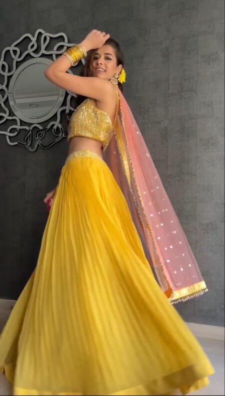 Georgette yellow lehenga with pink net dupatta and gold sequins blouse